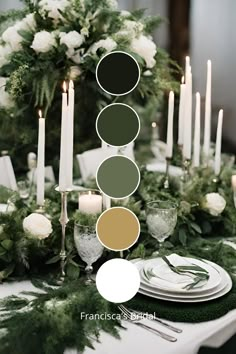 the table is set with candles, plates and greenery