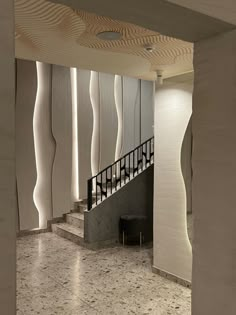 the interior of a building with marble floors and walls, along with an open staircase