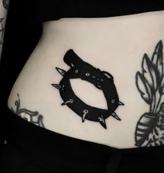 a woman's stomach with tattoos on it