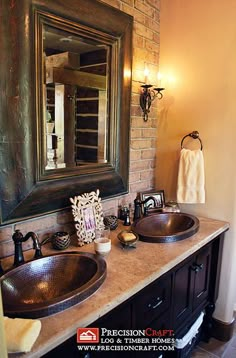 a bathroom with two sinks and a large mirror on the wall above it's counter