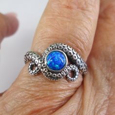 Fabulously Unique Solid Sterling Silver Octopus Ring, This One With A Fiery Blue Opal Eye At Its Center. Its Tentacles (Arms) Are Wrapped Around It. The Beautiful Lab Blue Opal Is Shocking! Gorgeous Detailing, Well Made. This Will Be Your New Fave! Face Height = 11mm. Stamped 925. **** Octopus Symbolism Pop Culture Depicts The Octopus As Evil And Scary Creature. But, In The Spiritual Realm, This Eight-Legged Creature Of The Sea Holds A Lot Of Positive Symbolism. Tap Into Octopus Energy For Intel Octopus Symbolism, Zombie Man, Opal Eyes, Octopus Ring, Spiritual Realm, Your Spirit Animal, The Octopus, Ring Opal, Blue Ring