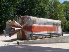 an old boat sitting on top of a cement bench