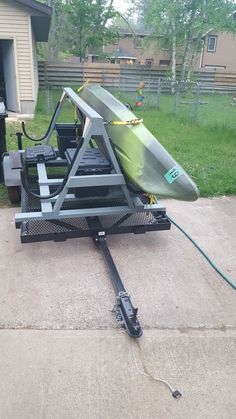 an upside down surfboard sitting on top of a trailer