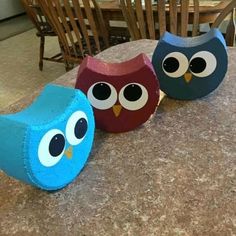 three colorful owls sitting on top of a table