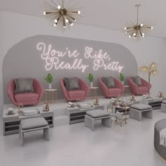 the salon is decorated with pink chairs and gold accents, along with white stools