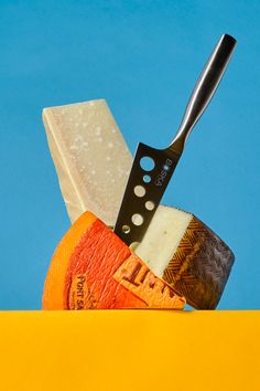 a cheese knife sitting on top of an orange