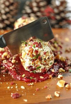 someone is cutting up some food on a wooden board