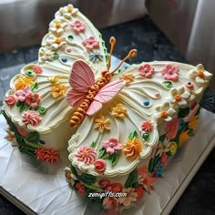 the cake is shaped like a butterfly with flowers on it