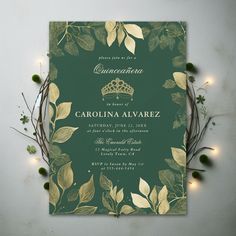 a green and gold wedding card with leaves on the front, surrounded by greenery