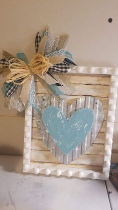 a wooden frame with a heart on it