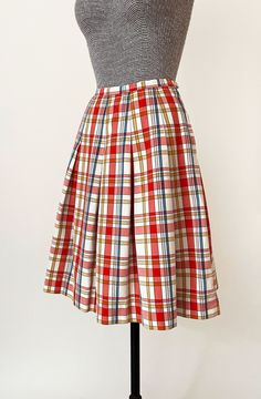 "1960s Miss Pat pleated skirt. Light red, blue, gold and white plaid pattern. High waisted with dropped pleats and a wide A line cut. Side zipper and button closure. In great vintage condition with a couple tiny specks - please see photos. All measurements are taken with the garment laying flat and doubled for the bust, waist, and hips. Waist: 22\" Hips: open Length: 22\" Label: Miss Pat Material: Not listed; looks / feels like cotton or cotton blend Size on Tag: N/A Approx. Fit: XXS Some garmen Plaid Pleated Skirt, Pleat Skirt, Satin Kimono, 60s Mod, Pleated Shorts, Periwinkle Blue, Virtual Closet, Mid Dresses, White Plaid