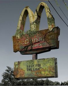 an old mcdonald's restaurant sign has been vandalized