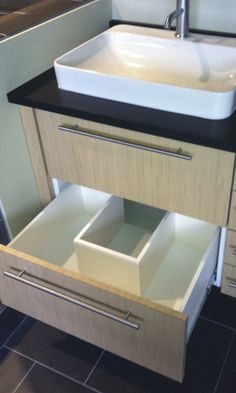 a bathroom with a sink and drawers in it