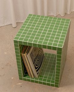 a green table with some books on it