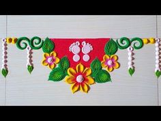 an artisticly decorated wall hanging with flowers and leaves