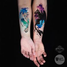 two people holding hands with tattoos on their arms and one has a fish tattoo on the arm