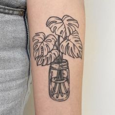 a black and white drawing of a plant in a mason jar on the left arm