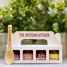 the artisan kitchen gift set includes three jars and a wooden spoon