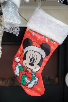 a mickey mouse christmas stocking hanging from a tree