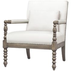 an upholstered white chair with wooden legs and studding on the armrests