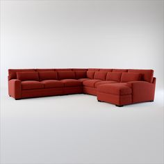 a red sectional couch sitting on top of a white floor