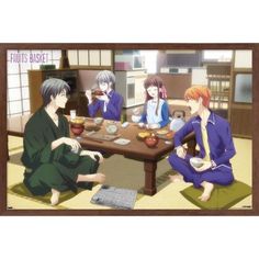 four people sitting around a table eating food