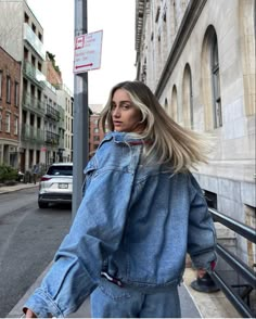 a woman with blonde hair walking down the street