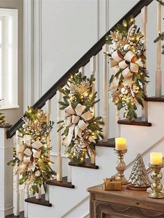 christmas decorations on the banisters and stairs with lit candles in front of them