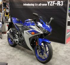 a blue and silver motorcycle is on display