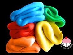 a pile of colorful towels sitting on top of each other in front of a black background