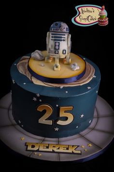 a birthday cake with a robot on top