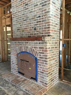 a brick fireplace in a house being built