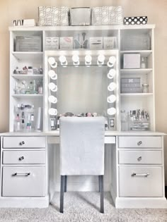 a white desk with lots of drawers and a mirror on the top shelf above it