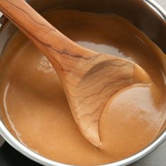 a wooden spoon in a pot filled with liquid