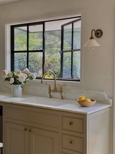 a kitchen with a sink, window and counter top in it's center area