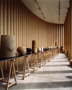 a row of vases sitting on top of a wooden table