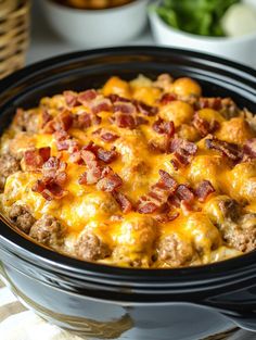 a casserole dish with meat and cheese in it sitting on a table next to other dishes