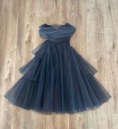 Beautiful XS navy blue tulle and satin 1950's dress by designer Jack Herzog. Pleating detal in tulle throughout dress is exquisite!! Metal side zipper and attached tulle shawl. There is a small hole in lace on the front top of inside of bodice. It is not noticeable when wearing the dress. Besides this small flaw the dress is in mint condition.SIZE & FITmeasurements while lying flat-(no tag)shoulder(attached shawl) 32”bust 24”waist,freelength 45" Blue Tulle Dress Short, Blue Tulle Dress With Lace Trim, Blue Tulle Evening Dress With Sweetheart Neckline, 1950s Tulle Dress, Elegant Blue Tulle Mini Dress, Tulle Shawl, Maroon Midi Dress, 1950 Dress, Crushed Velvet Dress