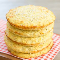 a stack of biscuits sitting on top of a red and white checkered table cloth