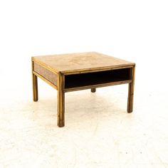 a small wooden table sitting on top of a white floor