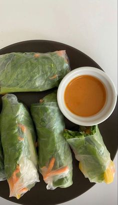 lettuce wrapped in paper with dipping sauce on the side