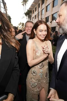 an image of two people talking to each other in the middle of a red carpet