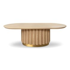 an oval wooden table with gold pedestals on the base and a circular wood table top