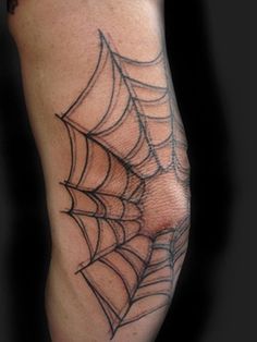 a spider web tattoo on the arm