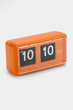 an orange alarm clock with the numbers ten and ten