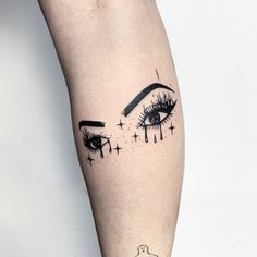 a woman's leg with an eye tattoo on it