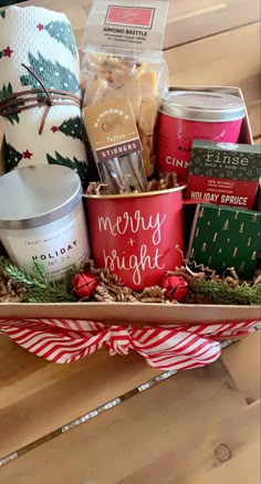 the holiday gift basket is filled with candles, cookies and other christmas gifts for someone special