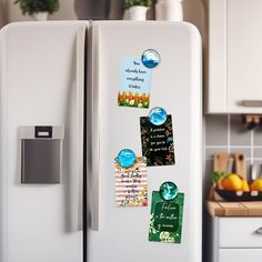 a white refrigerator with magnets on it in a kitchen