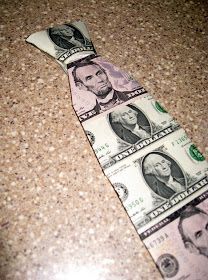 a tie made out of money sitting on top of a counter