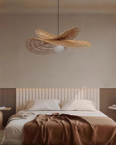 a large bed sitting under a light fixture in a bedroom